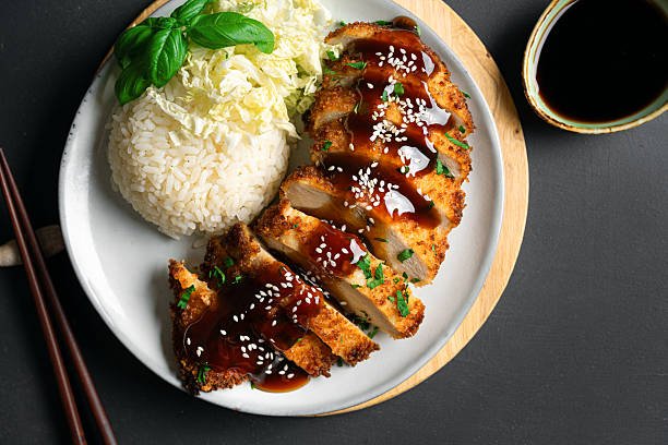 # Make this Easy Chicken Katsu Any Way You Like: Air Fryer, Deep Fried, and Oven Versions **Focus Keyword:** Make this Easy Chicken Katsu any way you like: Air Fryer, Deep Fried, and Oven Versions If you're craving a crispy, juicy, and satisfying meal that's easy to make at home, this recipe is exactly what you need. **Make this Easy Chicken Katsu any way you like: Air Fryer, Deep Fried, and Oven Versions** gives you the flexibility to prepare one of Japan's most loved comfort foods using the cooking method that works best for your kitchen. Whether you're trying to reduce oil with an air fryer, enjoy the traditional deep-fried version, or bake it in the oven for a healthier option, this recipe delivers delicious results every time. Chicken katsu is known for its crunchy golden coating and tender chicken inside, making it a favorite for weeknight dinners, family meals, and even meal prep. ## What Is Chicken Katsu? Chicken katsu is a popular Japanese dish made with boneless chicken breasts or thighs coated in flour, egg, and Japanese panko breadcrumbs before being cooked until crispy. It is commonly served with steamed rice, shredded cabbage, and a sweet and tangy katsu sauce. The secret to authentic chicken katsu is using panko breadcrumbs, which create a lighter and crunchier texture than regular breadcrumbs. ## Ingredients You'll Need To make this recipe, gather the following ingredients: * 2 boneless chicken breasts * Salt and black pepper * ½ cup all-purpose flour * 2 beaten eggs * 1½ cups Japanese panko breadcrumbs * Cooking oil (for deep frying) * Cooking spray (for air fryer or oven) For serving: * Steamed white rice * Shredded cabbage * Katsu sauce * Lemon wedges ## How to Prepare the Chicken Start by slicing each chicken breast horizontally if they are thick. Pound them gently until they are about half an inch thick. This helps the chicken cook evenly while staying juicy. Season both sides with salt and pepper. Prepare three bowls: 1. Flour 2. Beaten eggs 3. Panko breadcrumbs Coat each chicken piece in flour, dip it into the eggs, and finally cover it completely with panko breadcrumbs. Press the breadcrumbs gently so they stick well. ## Air Fryer Chicken Katsu If you want a healthier version with less oil, the air fryer is an excellent choice. ### Instructions * Preheat the air fryer to 390°F (200°C). * Lightly spray both sides of the breaded chicken with cooking spray. * Place the chicken in a single layer. * Cook for 10 to 12 minutes. * Flip halfway through cooking. * Continue cooking until the coating becomes golden brown and the internal temperature reaches 165°F (74°C). The air fryer creates an incredibly crispy coating while using very little oil. ## Deep Fried Chicken Katsu This is the traditional Japanese method and produces the crispiest texture. ### Instructions * Heat vegetable oil to 350°F (175°C). * Carefully lower the breaded chicken into the hot oil. * Fry for about 4 to 5 minutes per side. * Remove when golden brown. * Drain on a wire rack or paper towels. Deep frying gives the chicken its signature restaurant-style crunch. ## Oven-Baked Chicken Katsu Baking is another great option for anyone who prefers a lighter meal. ### Instructions * Preheat your oven to 425°F (220°C). * Place the breaded chicken on a wire rack over a baking tray. * Spray lightly with cooking oil. * Bake for 20 to 25 minutes. * Flip halfway through cooking. * Continue until crispy and fully cooked. The oven method produces a crunchy coating while keeping the chicken moist. ## Which Cooking Method Is Best? Each version has its own advantages. ### Air Fryer * Uses very little oil * Crispy texture * Quick cooking * Easy cleanup ### Deep Fried * Authentic Japanese flavor * Extra crispy coating * Rich golden color ### Oven Baked * Healthier alternative * Great for cooking multiple pieces * Simple and convenient The best method depends on your personal preference and available kitchen equipment. ## Best Side Dishes for Chicken Katsu Chicken katsu pairs well with many classic sides. Popular options include: * Steamed jasmine rice * Japanese short-grain rice * Miso soup * Shredded cabbage salad * Potato salad * Pickled vegetables * Edamame A drizzle of katsu sauce completes the meal with its sweet and savory flavor. ## Tips for Perfect Chicken Katsu For the best results every time: * Always use fresh panko breadcrumbs. * Don't skip seasoning the chicken. * Cook until the internal temperature reaches 165°F. * Let the cooked chicken rest for a few minutes before slicing. * Slice against the grain for extra tenderness. ## Storage and Reheating Leftover chicken katsu stores well. * Refrigerate in an airtight container for up to three days. * Freeze for up to two months. * Reheat in an air fryer or oven to restore crispiness. * Avoid microwaving if possible, as it softens the coating. ## Frequently Asked Questions ### Can I use chicken thighs? Yes. Boneless chicken thighs are even juicier and work perfectly for this recipe. ### Can I make chicken katsu gluten-free? Yes. Use gluten-free flour and gluten-free panko breadcrumbs. ### What sauce goes with chicken katsu? Traditional Japanese katsu sauce is the most popular choice, but tonkatsu sauce, Japanese curry, spicy mayo, or even sweet chili sauce also taste great. ### Can I prepare it ahead of time? Yes. Bread the chicken in advance and refrigerate it for several hours before cooking. ## Final Thoughts If you've been searching for a flexible recipe that delivers restaurant-quality results at home, **Make this Easy Chicken Katsu any way you like: Air Fryer, Deep Fried, and Oven Versions** is the perfect choice. Whether you prefer the healthier air fryer version, the classic deep-fried crunch, or the convenient oven-baked method, you'll enjoy tender chicken wrapped in a crispy golden coating every time. Serve it with steamed rice, fresh cabbage, and your favorite katsu sauce for a comforting meal that's sure to become a family favorite. No matter which cooking method you choose, this chicken katsu recipe is simple enough for beginners and delicious enough to impress everyone at the table.
